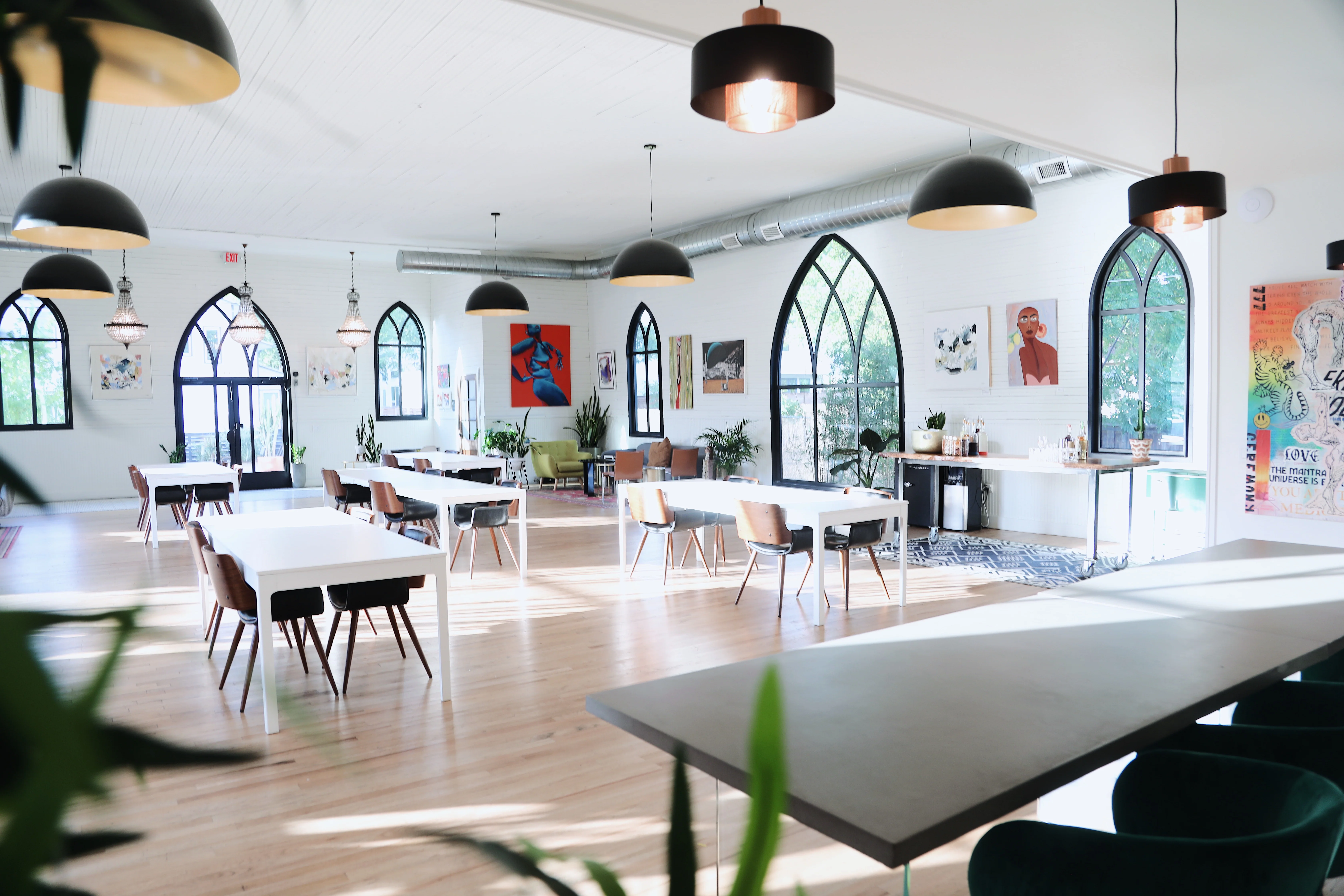 The Cathedral coworking space in East Austin, a converted church with gothic arched windows and art on the walls