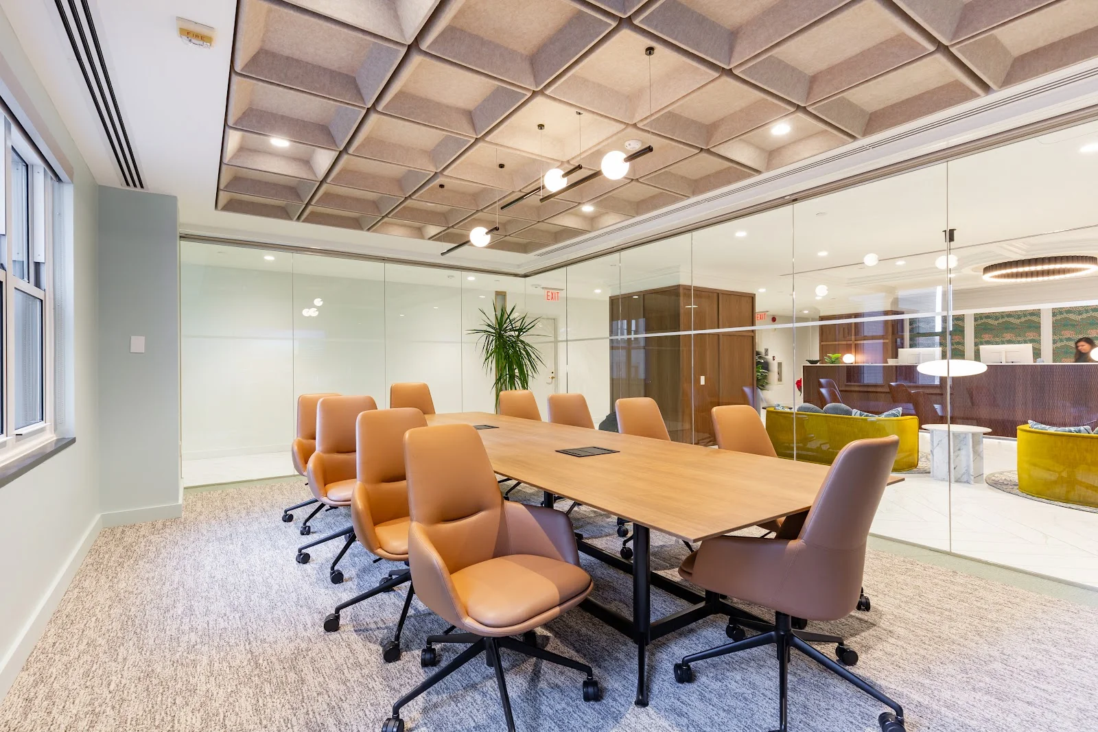 Carr Workplaces The Willard executive boardroom with leather tan chairs, walnut conference table, and geometric acoustic ceiling panels