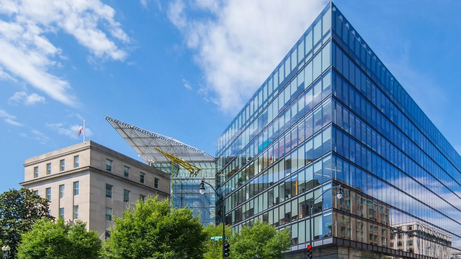 Carr Workplaces Capitol Hill modern glass curtain-wall building exterior with blue sky and surrounding DC architecture