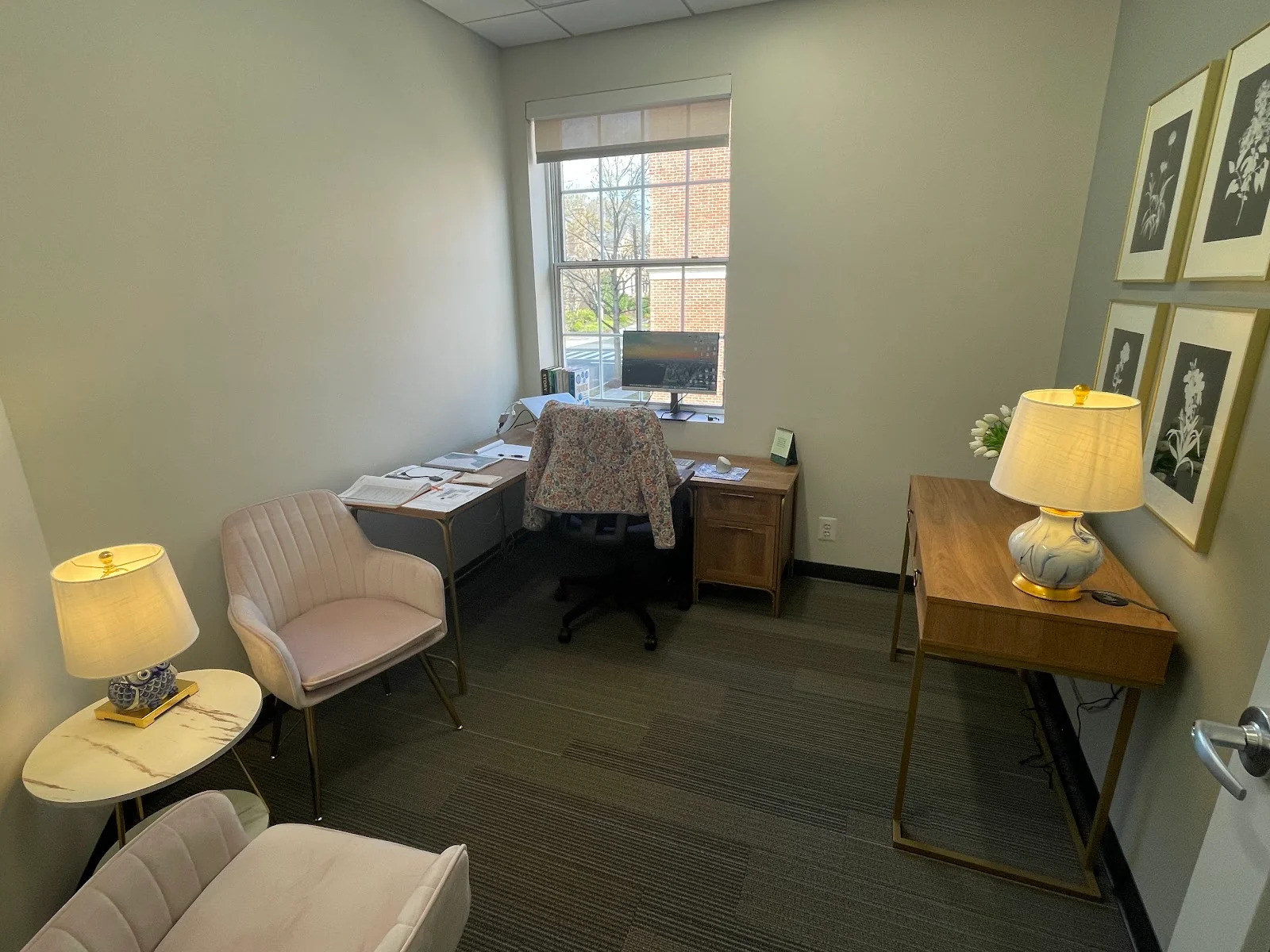 Regus Spring Valley private office with sage green walls, velvet armchair, desk by window, and elegant lamps