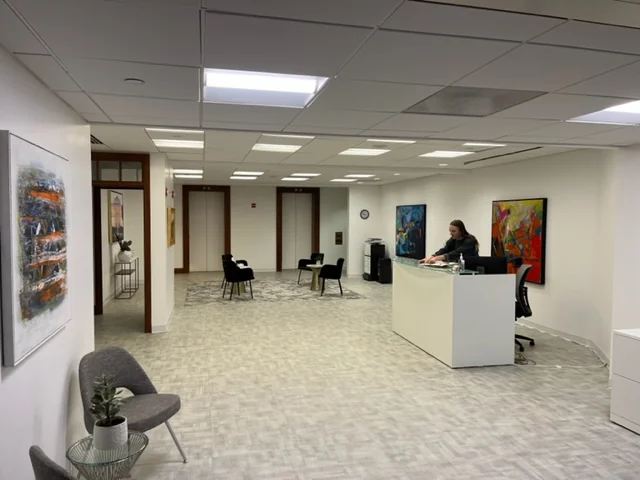 Oval Offices DC reception area with abstract paintings, modern furniture and professional atmosphere